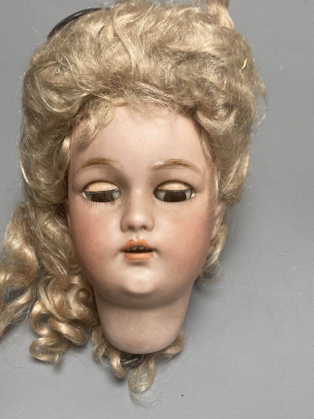 A Kammer & Reinhardt / Simon & Halbig bisque doll head, 10cm, three other German bisque doll heads and two English bisque doll heads,